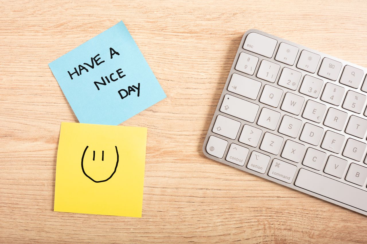 services-bg A cheerful desk setup with a note saying 'Have a Nice Day' next to a keyboard.